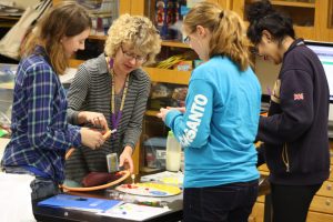 Johnston Middle School students and teacher Lisa Horsch work on a science project. 