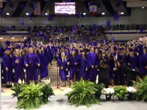 Johnston High School students at the graduation ceremony throw their caps up in the air. 
