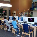 Elementary students doing research on library computers