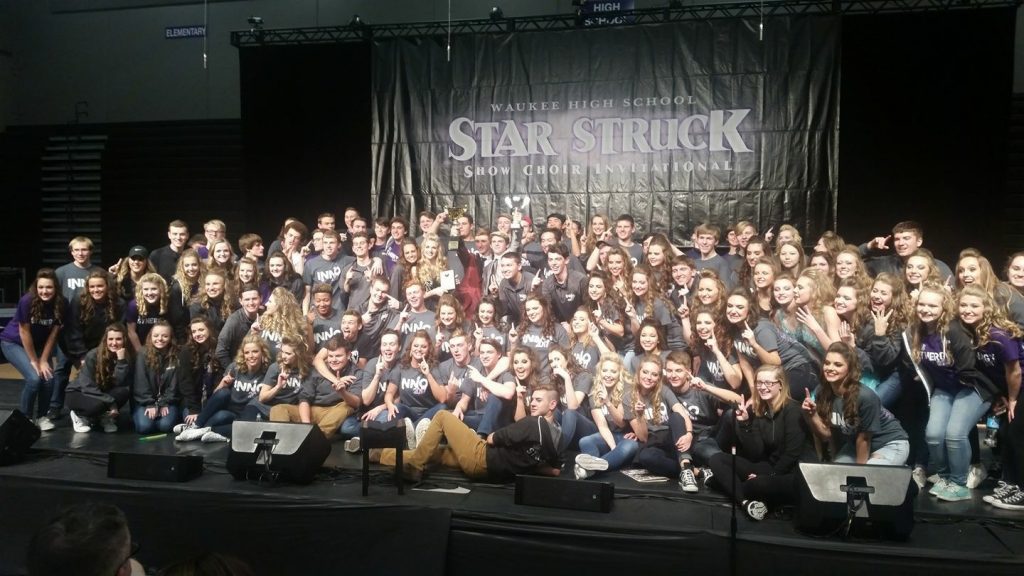 Student members of the JHS Innovation and Synergy Show Choirs pose for a photo with their grand championship trophies