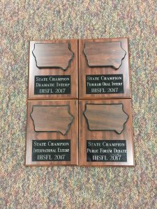 Photo of four plaques won at the Iowa Forensic League State Tournament.