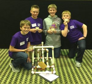 The Summit Catapult Design Team consisting of Jake Wagner, Cade Caffrey, Sam Lindgren, & Will Sheeley poses for a photo