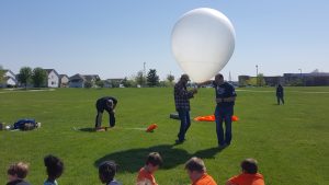 The DMACC crew prepares the weather balloon for launch. 