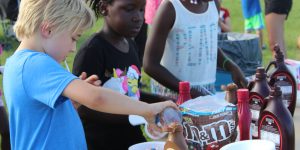 Kids enjoy building an ice cream sundae at the annual Sundae in the park event.