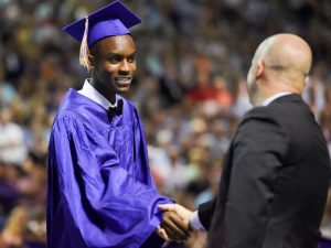 Johnston graduate Patrick Bose shakes hands with Principal Ryan Woods at the JHS Commencement Ceremony