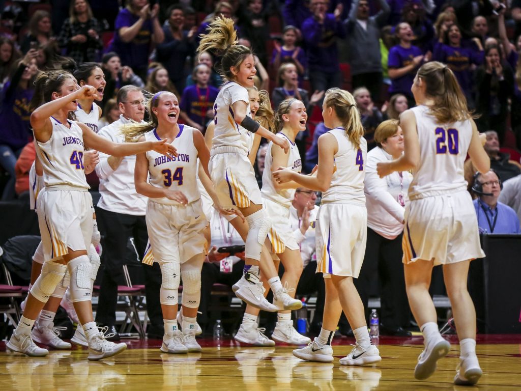 The Johnston girls basketball team celebrates their win over Waukee. Photo by Rodney White, Des Moines Register.