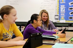 Shannon DaRos-Hall works with her students during a recent social studies project. 