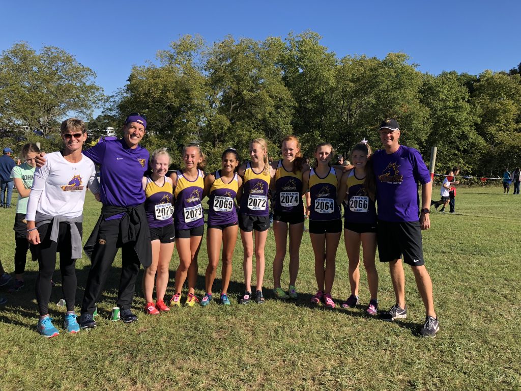 photo of the girls cross country coaches and some team members