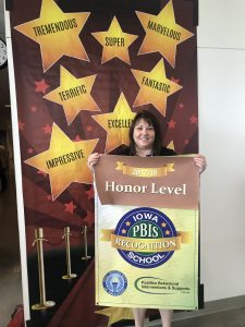 Beaver Creek employee holds up recognition banner