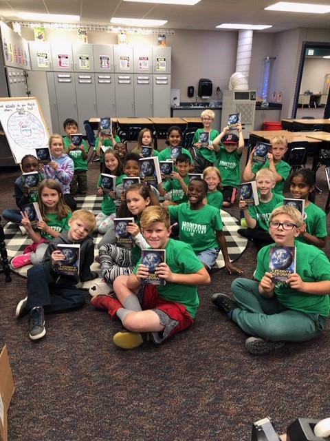 Horizon third graders pose with their new dictionaries from the Johnston Kiwanis service club. 