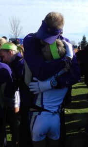 Coach Hennes and Jordyn Kleve hug at the 2014 State cross country meet