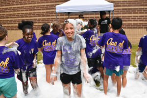 5th grade student smiles, covered in bubbles